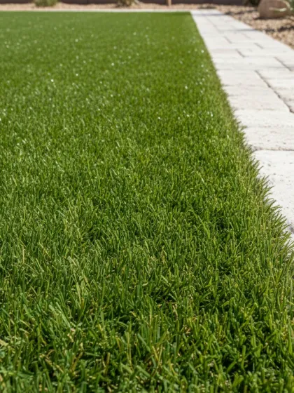 Close-up of artificial turf lawn meeting a paver border